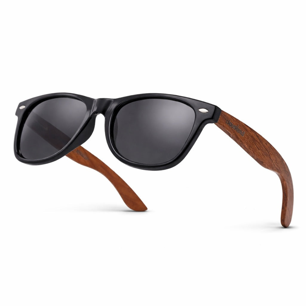 Sunglasses with black frames and wooden arms on a white background