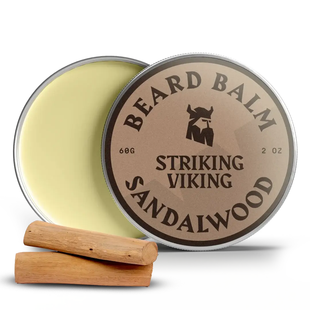 Sandalwood beard balm tin with lid open, two wood pieces beside.