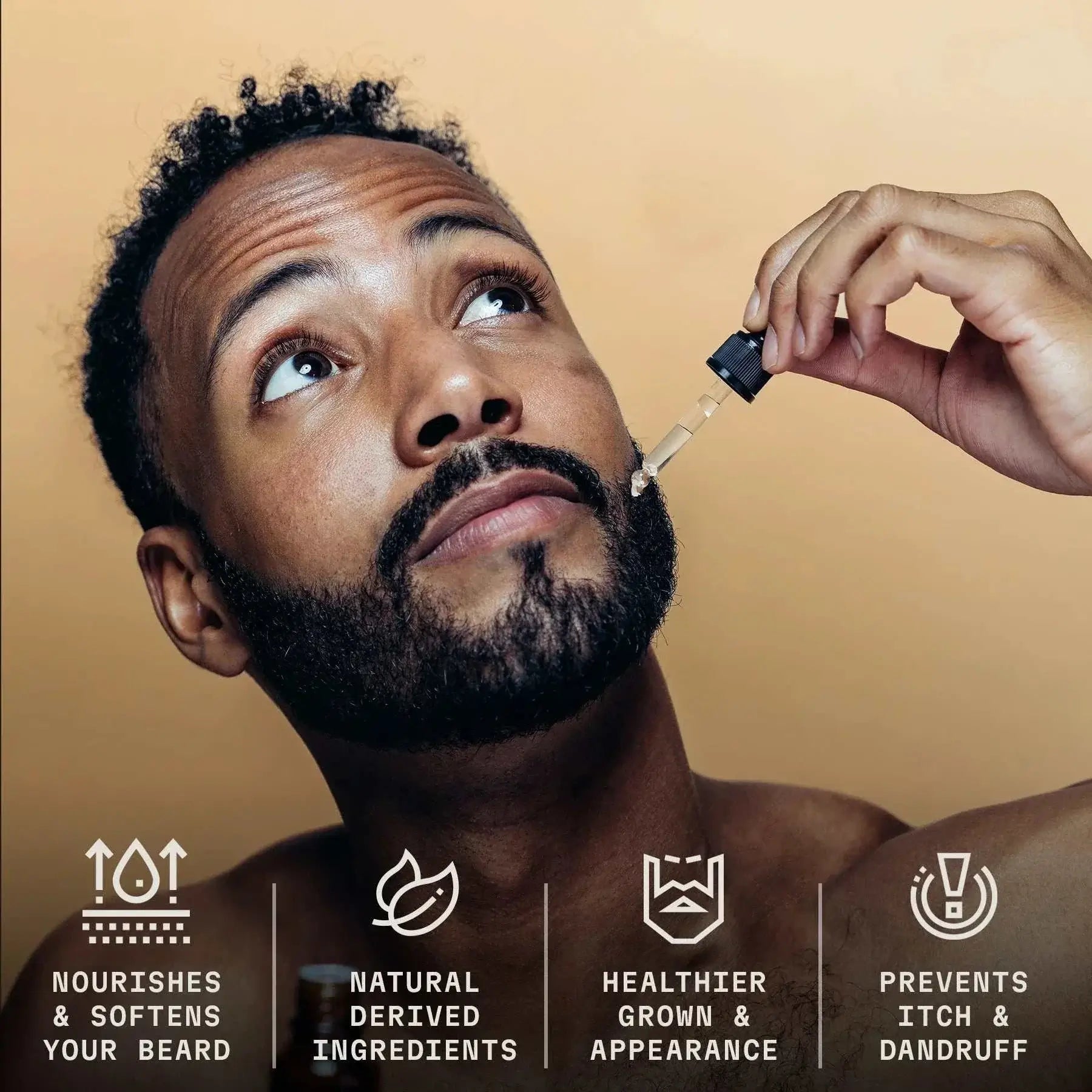 Man applying citrus beard oil with dropper, promoting healthier beard growth, softness, and reduced irritation.